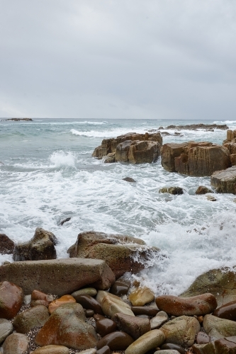 Coastal waves and rocks on overcast day - Australian Stock Image