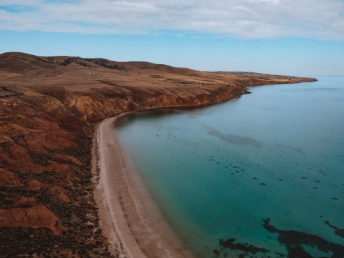Coastline with rolling hills and calm blue ocean - Australian Stock Image