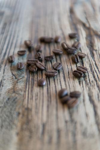 Coffee beans with wood grain table background - Australian Stock Image