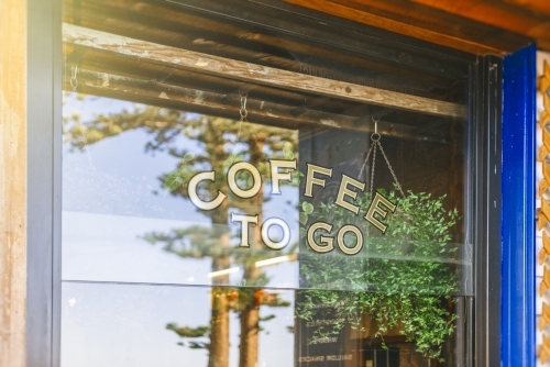 Coffee shop window with reflection of trees