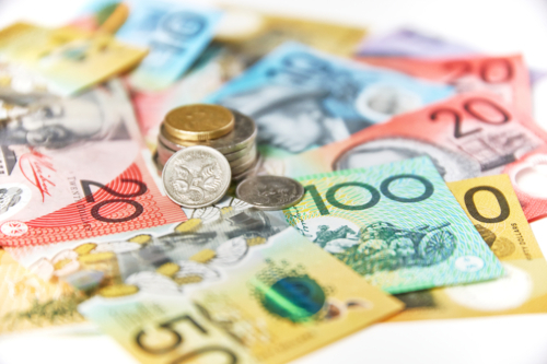 Collection of Australian banknotes and coins scattered on a flat surface - Australian Stock Image