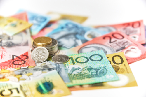 Collection of Australian banknotes and coins scattered on a flat surface - Australian Stock Image