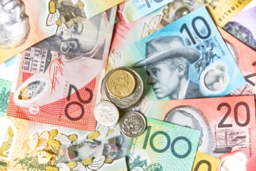 Collection of Australian banknotes and coins scattered on a flat surface. - Australian Stock Image