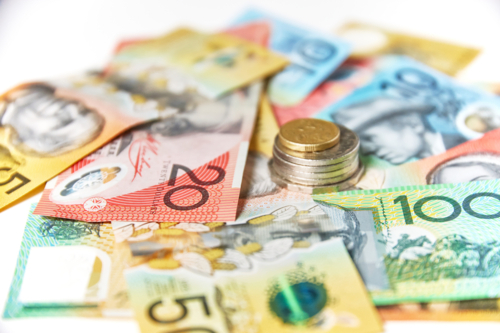 Collection of Australian banknotes with coins stack on a flat surface - Australian Stock Image