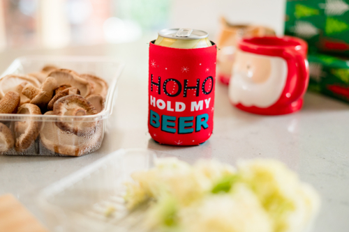 Colourful decorations, presents, and a festive drink holder set a joyful mood during Christmastime - Australian Stock Image