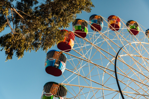 Colourful Ferris Wheel Ride Against a Blue Sky in the Afternoon Sun - Australian Stock Image