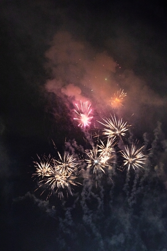 Colourful fireworks display in sky at night - Australian Stock Image