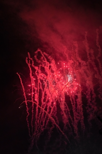 Colourful fireworks display in sky at night - Australian Stock Image