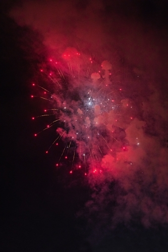 Colourful fireworks display in sky at night - Australian Stock Image