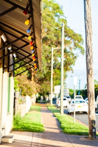 Colourful lights along awning of corner store - Australian Stock Image