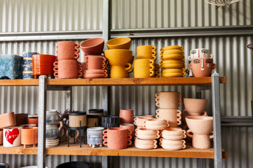 Colourful plant pots for sale in shed at nursery small business - Australian Stock Image