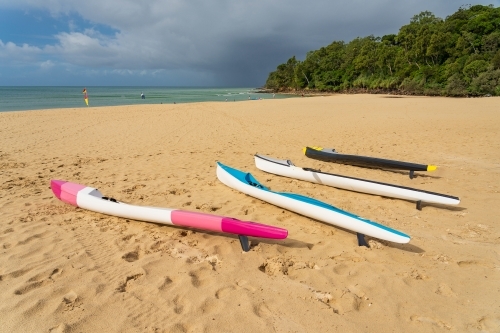Colourful surf skies lying on a golden sandy beach - Australian Stock Image
