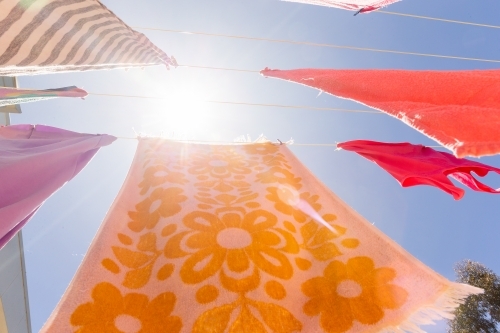 Colourful towels and swimmers hanging on washing line - Australian Stock Image