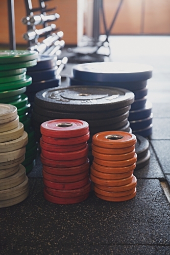 Colourful weights in an indoor gym - Australian Stock Image