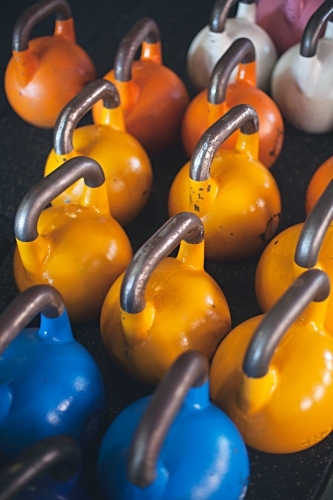 Colourful weights in an indoor gym - Australian Stock Image