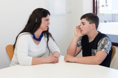 Concerned mother in conversation with teenage son - Australian Stock Image