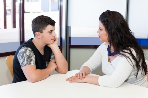 concerned mother in conversation with teenage son