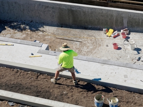 Concrete mixing and pool building with cement by hand with tradies - Australian Stock Image