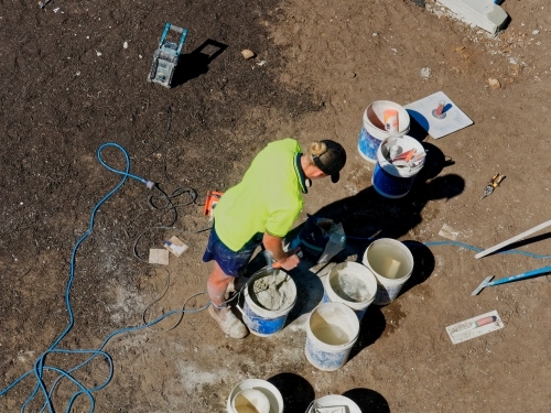 Concrete mixing and pool building with cement by hand with tradies - Australian Stock Image