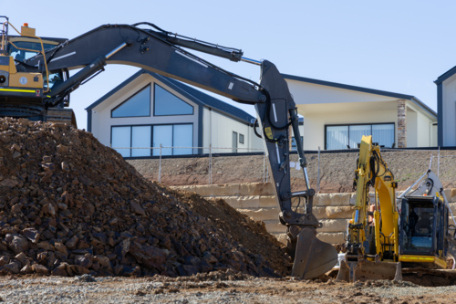 Construction site with diggers levelling out ground for house build - Australian Stock Image