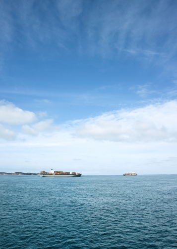 Container ships passing each other at the heads