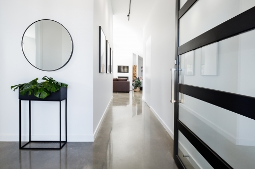 Contemporary home entry with polished concrete floors - Australian Stock Image