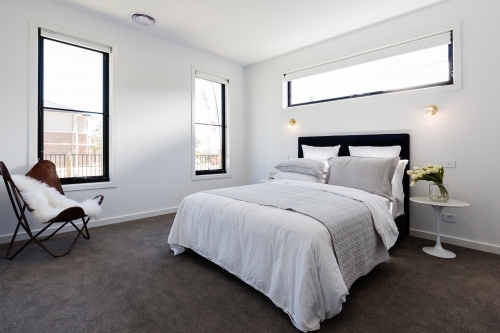 Contemporary master bedroom suite in a luxury home - Australian Stock Image