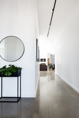 Contemporary new home entry with polished concrete floors