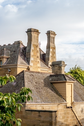 Convict sandstone chimney stacks in the early morning sunlight - Australian Stock Image