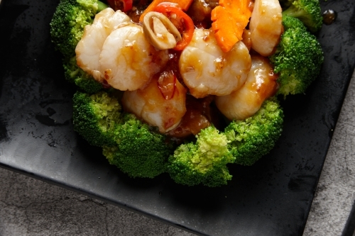 Cooked prawns and vegetables on plate - Australian Stock Image