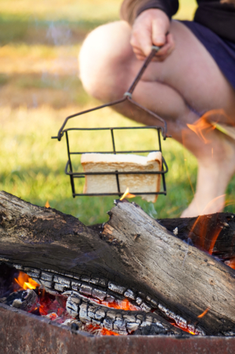 Cooking bread on a campfire - Australian Stock Image