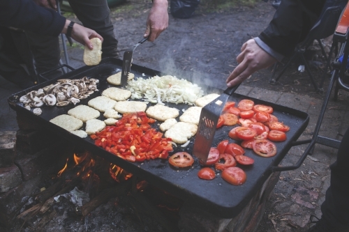 Cooking outdoor camping breakfast on campfire hot plate