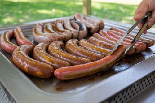 Cooking sausages on a barbecue