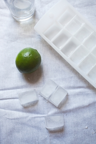 Cool glass of water with ice and mint on tabletop - Australian Stock Image
