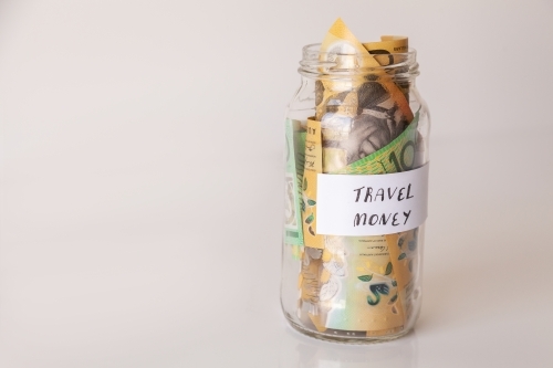 Copy space and jar of australian notes with travel money written on it - Australian Stock Image