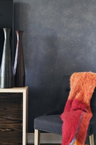 Corner bedroom nook with grey fabric chair and table - Australian Stock Image