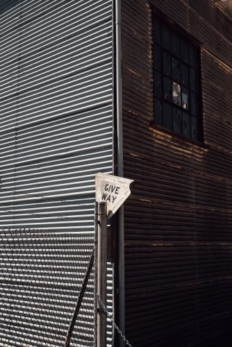 Corrugated iron mining building and fence with a weathered sign - Australian Stock Image