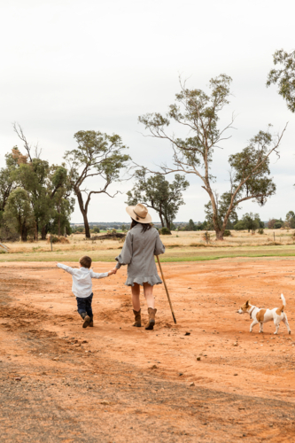 Country mum walking along dirt road - Australian Stock Image