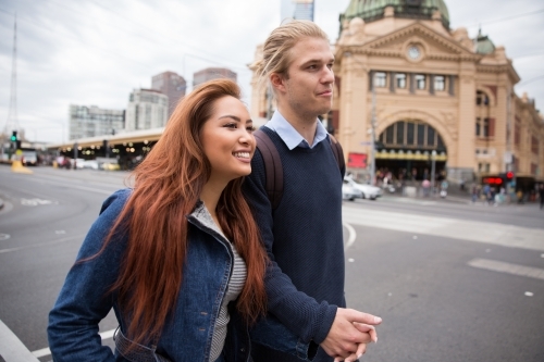 Couple Crossing Flinders Street Melbourne - Australian Stock Image