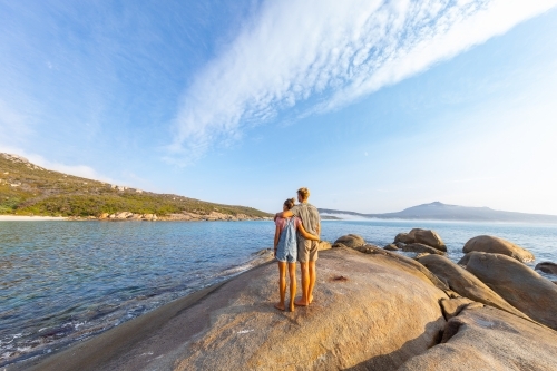 couple from behind looking out onto seascape - Australian Stock Image