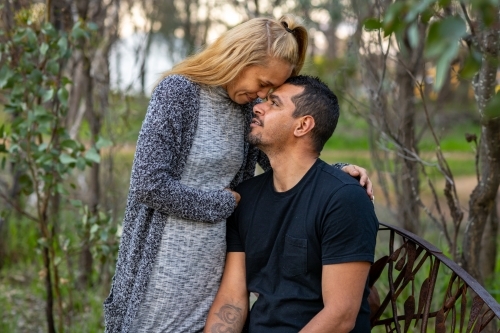 couple in intimate moment in bush park - Australian Stock Image