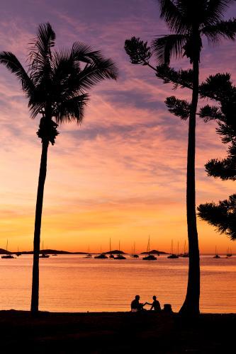 Couple on beach at sunset. - Australian Stock Image