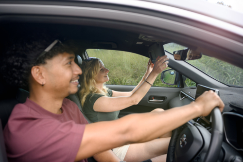 Couple sitting together in a car driving - Australian Stock Image