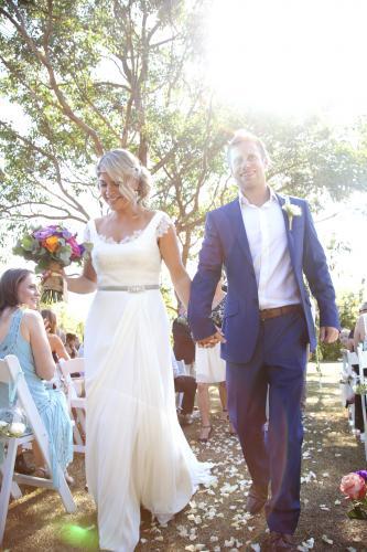 Couple walking back down the aisle after getting married - Australian Stock Image