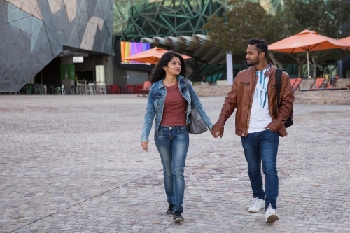 Couple Walking in Federation Square - Australian Stock Image