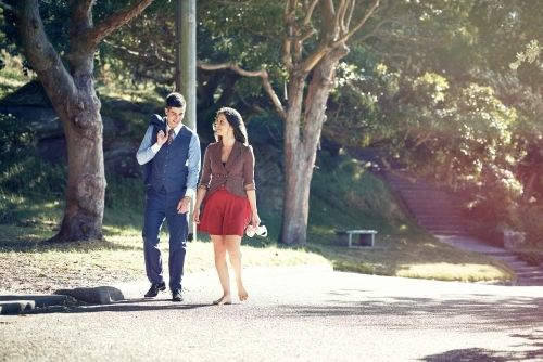 Couple walking in the park in office clothing