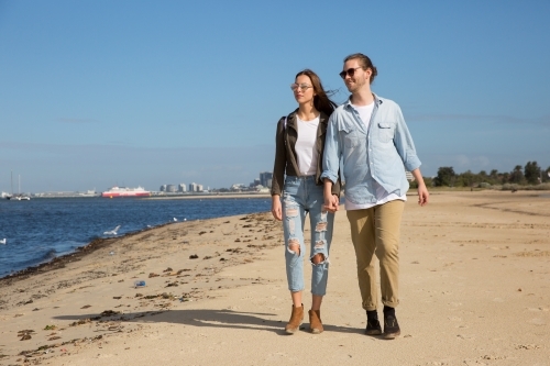 Couple Walking on Beach at South Melbourne - Australian Stock Image