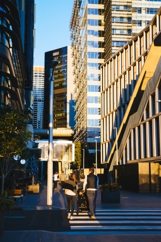 Couple walking with pram around the city