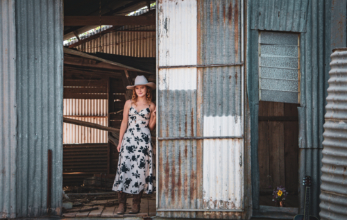 Cowgirl standing in a shearing shed - Australian Stock Image