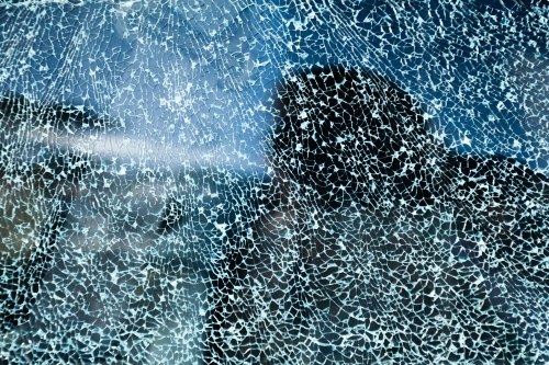 Cracks in glass of shattered car window - Australian Stock Image
